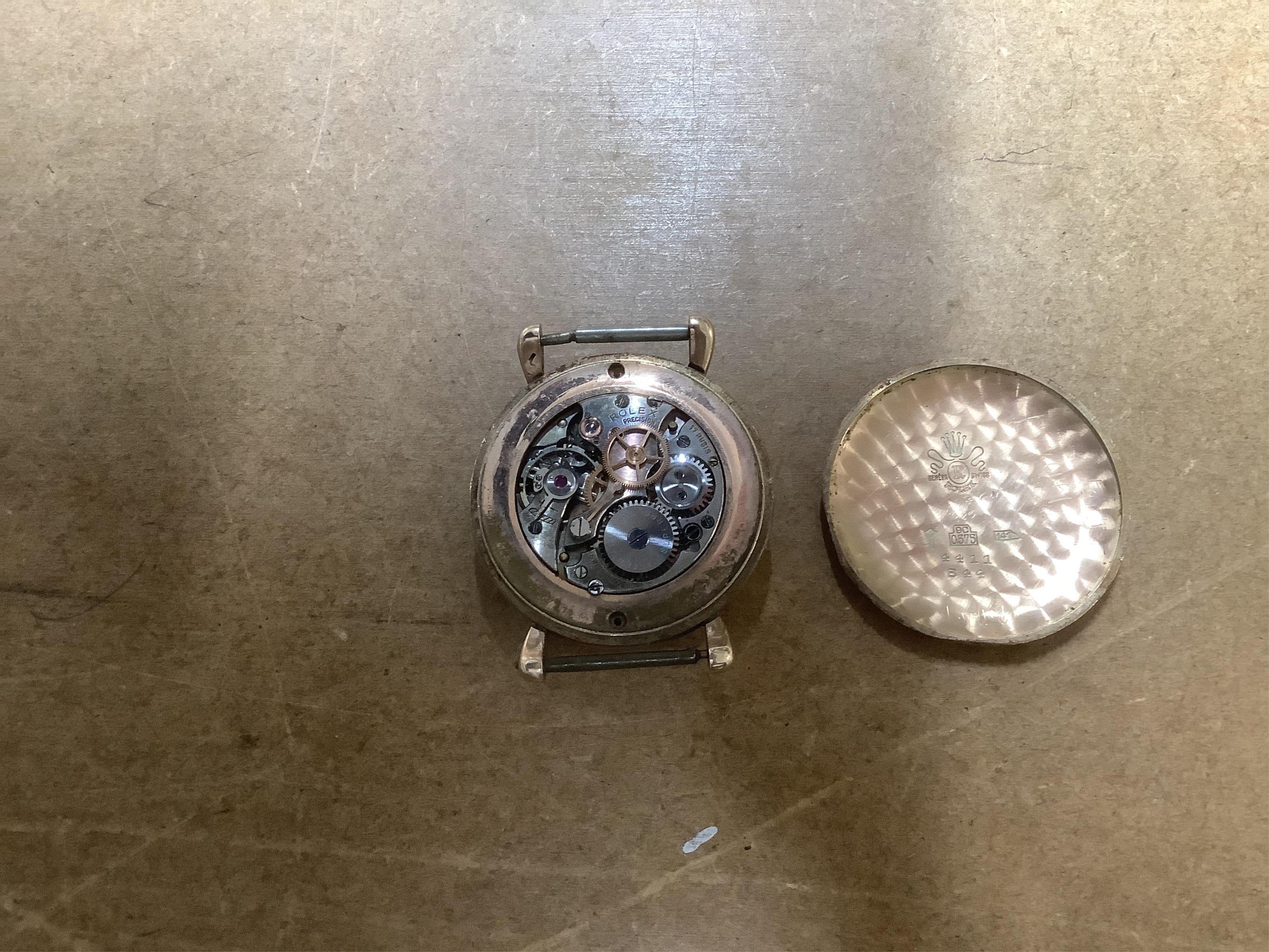 A gentleman's 1940's? 9ct gold Rolex manual wind wrist watch, with signed Super Balance movement, the inner case back numbered 4411 over 844, case diameter 34mm, no strap or winding crown. Condition - poor
